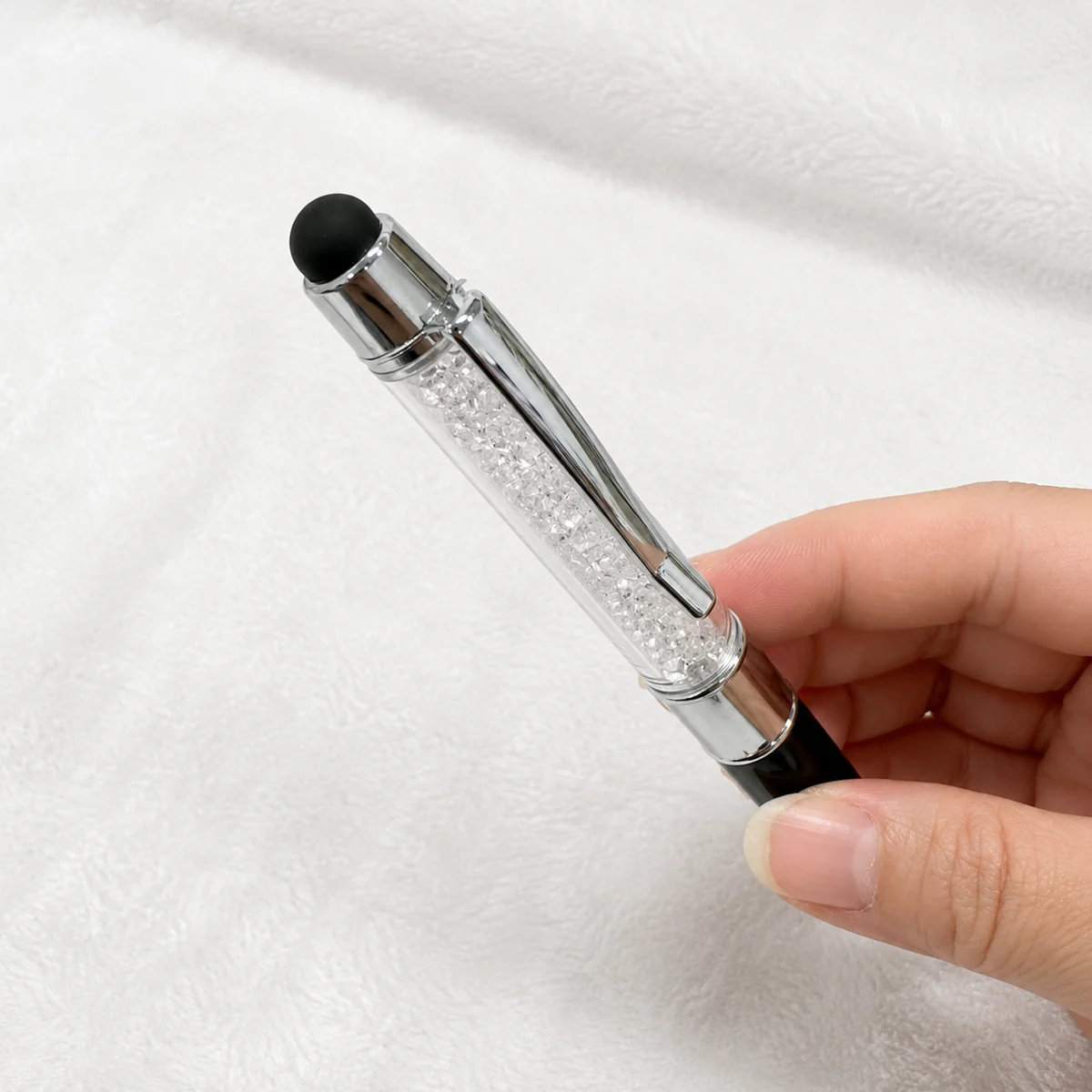 Close-up of the soft-touch stylus and crystal barrel on a custom USB pen