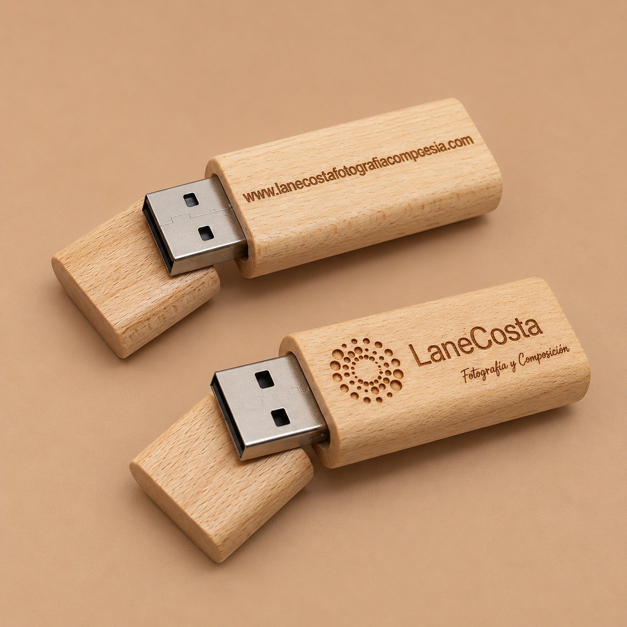 Two wooden USB drives engraved with a small website URL and a secondary tagline, illustrating the limits of fine secondary text at engraving size.