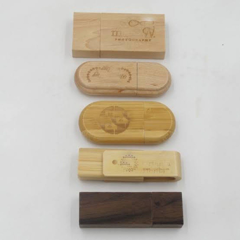 Engraved wooden USB drive styles arranged on a white background