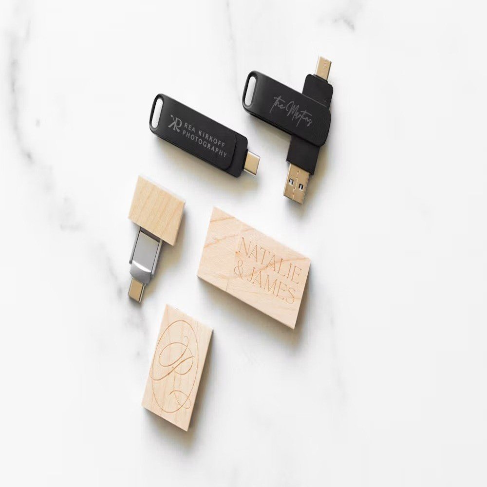 Wood and black USB drives with different connector types and logo engraving