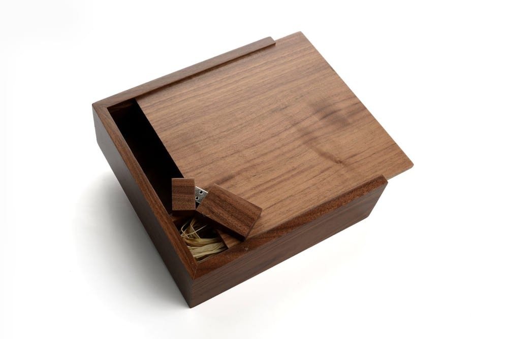 Solid walnut slide-top wooden box holding a mini wooden USB flash drive